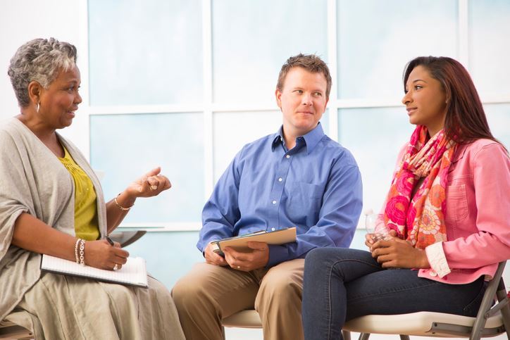 Three people sitting together, illustrating an Emotionally Focused Therapy session.